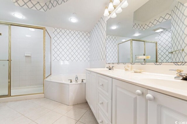 341 S Dunes Dr Unit C-34, Pawleys Island, SC 29585 - bathroom with wallpapered walls, a bath, a shower stall, double vanity, and tile patterned flooring