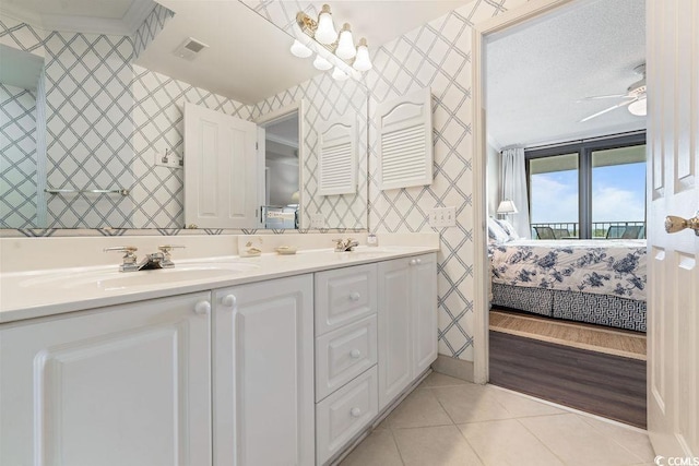 341 S Dunes Dr Unit C-34, Pawleys Island, SC 29585 - ensuite bathroom featuring wallpapered walls, double vanity, tile patterned floors, and a ceiling fan