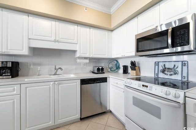341 S Dunes Dr Unit C-34, Pawleys Island, SC 29585 - kitchen featuring appliances with stainless steel finishes, ornamental molding, a sink, decorative backsplash, and white cabinetry