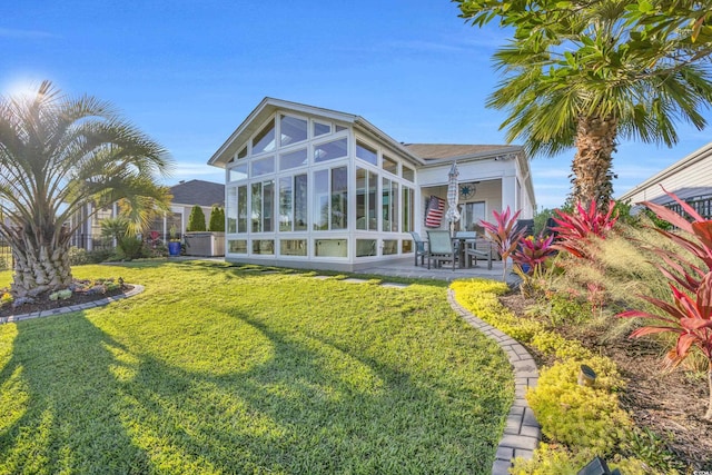 2653 Orion Loop, Myrtle Beach, SC 29577 - rear view of property with a sunroom, a patio, and a yard