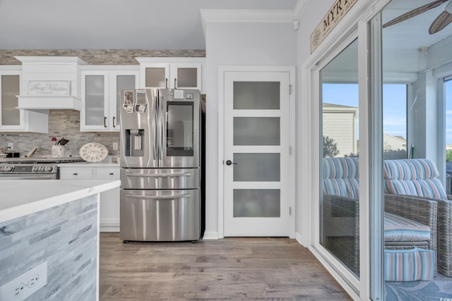 2653 Orion Loop, Myrtle Beach, SC 29577 - kitchen featuring appliances with stainless steel finishes, ornamental molding, wood finished floors, white cabinets, and light countertops