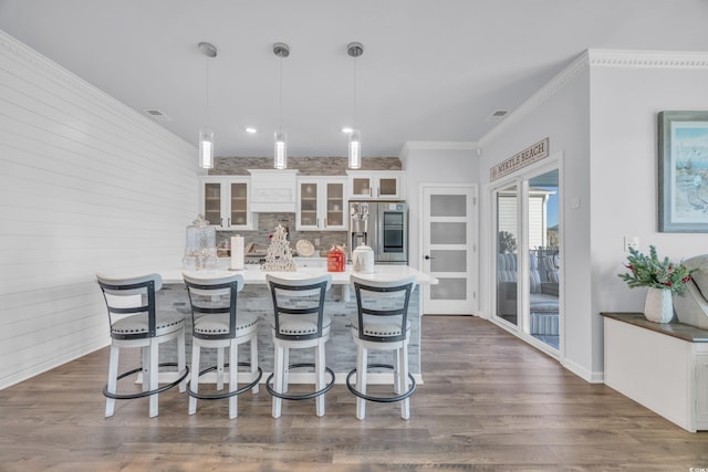 2653 Orion Loop, Myrtle Beach, SC 29577 - kitchen with stainless steel refrigerator with ice dispenser, a breakfast bar, white cabinetry, glass insert cabinets, and hanging light fixtures