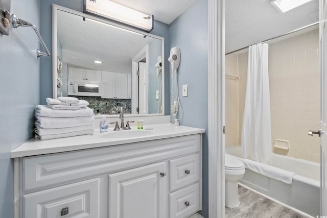 2001 S Ocean Blvd Unit 815, Myrtle Beach, SC 29577 - bathroom featuring a textured ceiling, vanity, shower / bath combo, and wood finished floors