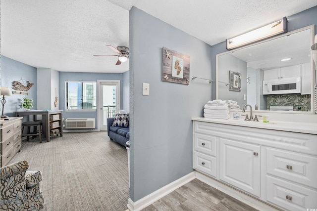 2001 S Ocean Blvd Unit 815, Myrtle Beach, SC 29577 - bathroom featuring a textured ceiling, vanity, an AC wall unit, and ceiling fan