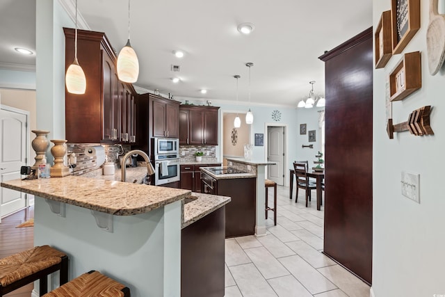 1051 Academy Dr, Conway, SC 29526 - kitchen with stainless steel appliances, crown molding, a breakfast bar area, a peninsula, and decorative backsplash