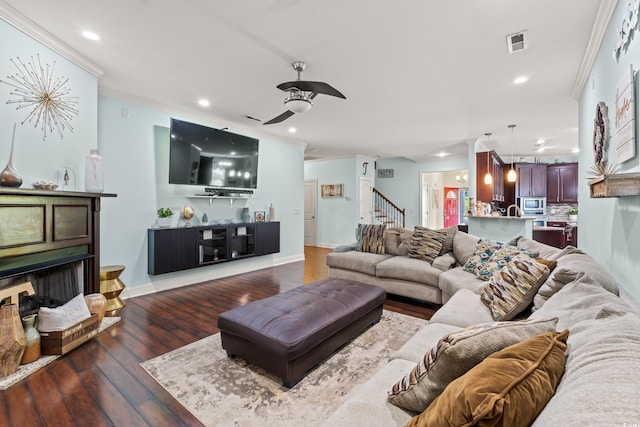 1051 Academy Dr, Conway, SC 29526 - living area featuring crown molding, stairs, dark wood-type flooring, recessed lighting, and a ceiling fan