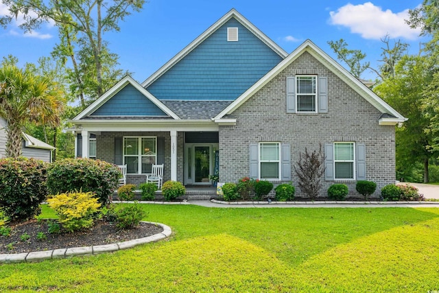 1051 Academy Dr, Conway, SC 29526 - craftsman house featuring covered porch, a front yard, and brick siding