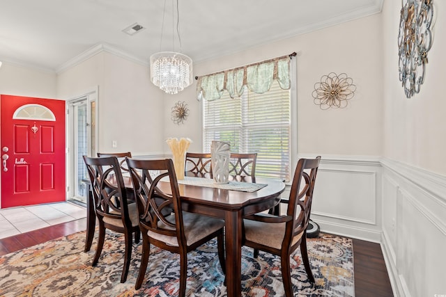 1051 Academy Dr, Conway, SC 29526 - dining room featuring wood finished floors, ornamental molding, a chandelier, and wainscoting
