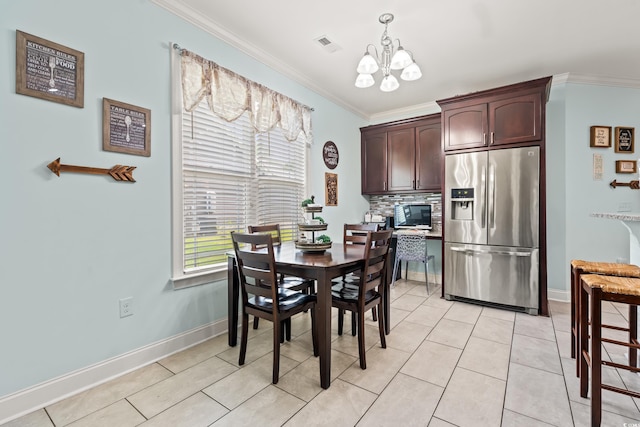 1051 Academy Dr, Conway, SC 29526 - dining area with crown molding, a chandelier, baseboards, and light tile patterned flooring