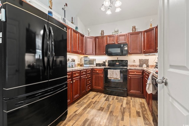 1068 Lizzie Ln, Surfside Beach, SC 29575 - kitchen featuring black appliances, light wood-type flooring, dark brown cabinets, and a chandelier