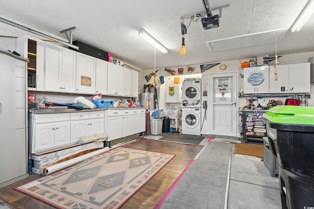1068 Lizzie Ln, Surfside Beach, SC 29575 - garage featuring estacked washer and dryer, a garage door opener, and fridge