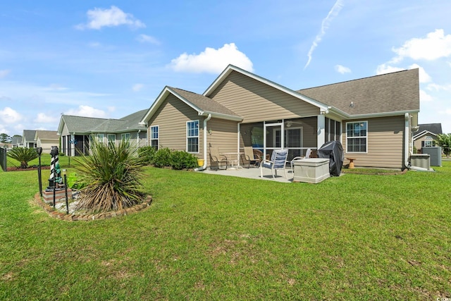 1068 Lizzie Ln, Surfside Beach, SC 29575 - rear view of house with a sunroom, a patio area, a yard, and central AC unit