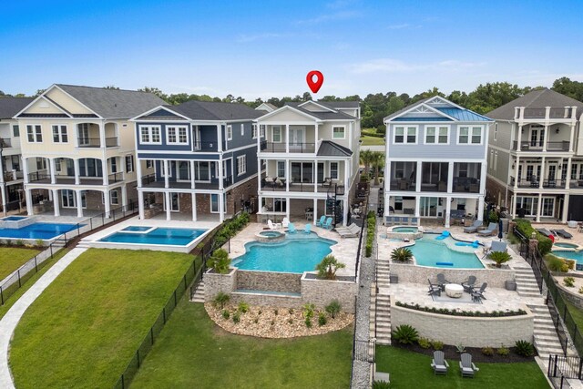 433 Saint Julian Ln, Myrtle Beach, SC 29579 - back of property featuring a balcony, a pool with connected hot tub, a residential view, and stairs