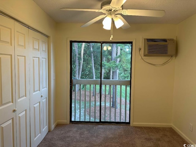 610 Putters Ln Unit H209, Little River, SC 29566 - unfurnished bedroom with a wall unit AC, carpet flooring, a closet, a textured ceiling, and a ceiling fan