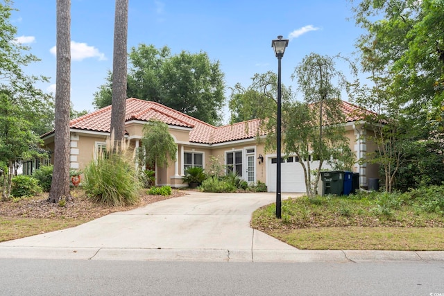 1501 Harbor Dr, North Myrtle Beach, SC 29582 - mediterranean / spanish home with an attached garage, a tiled roof, stucco siding, and driveway