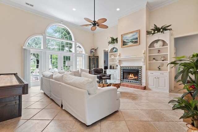 1501 Harbor Dr, North Myrtle Beach, SC 29582 - living area with crown molding, french doors, a tiled fireplace, built in features, and a ceiling fan
