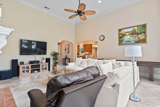 1501 Harbor Dr, North Myrtle Beach, SC 29582 - living area featuring arched walkways, a ceiling fan, ornamental molding, a chandelier, and baseboards