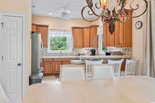 1501 Harbor Dr, North Myrtle Beach, SC 29582 - kitchen with appliances with stainless steel finishes, tasteful backsplash, brown cabinets, a ceiling fan, and recessed lighting