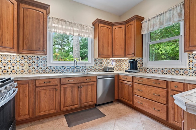 1501 Harbor Dr, North Myrtle Beach, SC 29582 - kitchen with stainless steel appliances, a sink, and brown cabinets