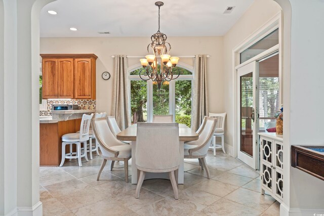 1501 Harbor Dr, North Myrtle Beach, SC 29582 - dining area with a chandelier, recessed lighting, arched walkways, and baseboards