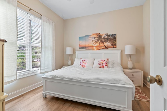 1501 Harbor Dr, North Myrtle Beach, SC 29582 - bedroom featuring multiple windows, wood finished floors, baseboards, and ceiling fan