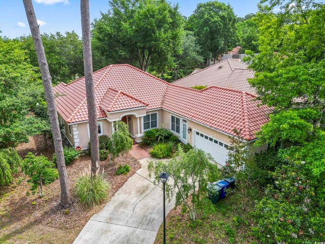 1501 Harbor Dr, North Myrtle Beach, SC 29582 - view of front of house with a tiled roof, stucco siding, and a garage