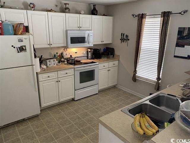 134 Butkus Dr Unit 7, Myrtle Beach, SC 29588 - kitchen featuring white appliances, white cabinetry, and light countertops