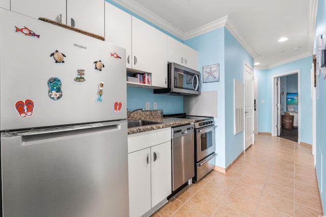 300 N Ocean Blvd Unit 122, North Myrtle Beach, SC 29582 - kitchen featuring stainless steel appliances, a sink, crown molding, white cabinetry, and dark stone countertops