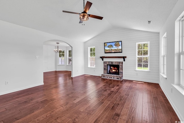 553 Fox Chase Dr, Conway, SC 29527 - unfurnished living room featuring ceiling fan, dark wood-type flooring, vaulted ceiling, a chandelier, and a brick fireplace