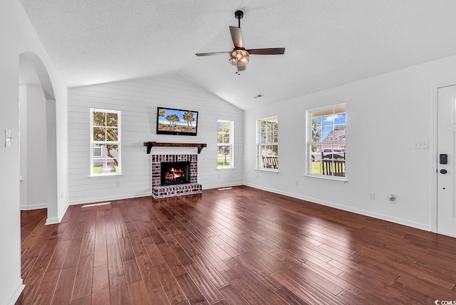 553 Fox Chase Dr, Conway, SC 29527 - unfurnished living room featuring a ceiling fan, baseboards, a fireplace, wood finished floors, and vaulted ceiling