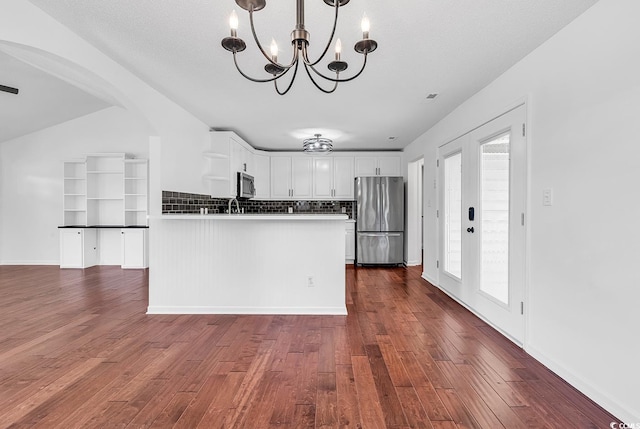 553 Fox Chase Dr, Conway, SC 29527 - kitchen featuring stainless steel appliances, open shelves, a chandelier, dark wood finished floors, and white cabinetry