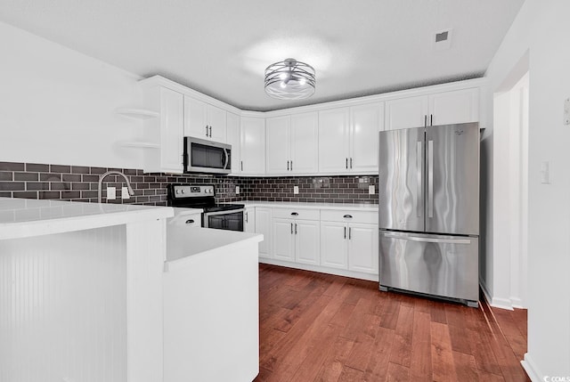 553 Fox Chase Dr, Conway, SC 29527 - kitchen with stainless steel appliances, white cabinets, and decorative backsplash