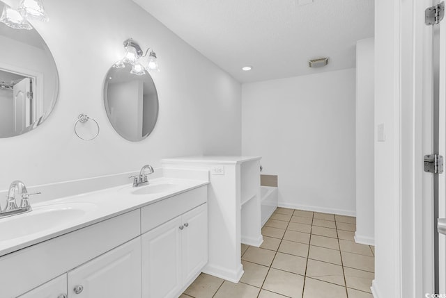 553 Fox Chase Dr, Conway, SC 29527 - full bathroom with double vanity, a bath, tile patterned flooring, a textured ceiling, and baseboards