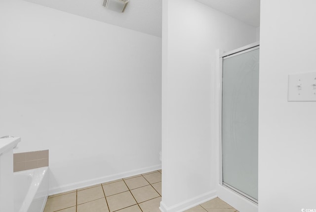 553 Fox Chase Dr, Conway, SC 29527 - bathroom featuring a stall shower, toilet, a bath, tile patterned floors, and baseboards