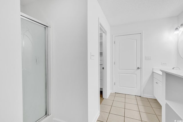 553 Fox Chase Dr, Conway, SC 29527 - bathroom featuring vanity, a shower stall, tile patterned flooring, baseboards, and a textured ceiling
