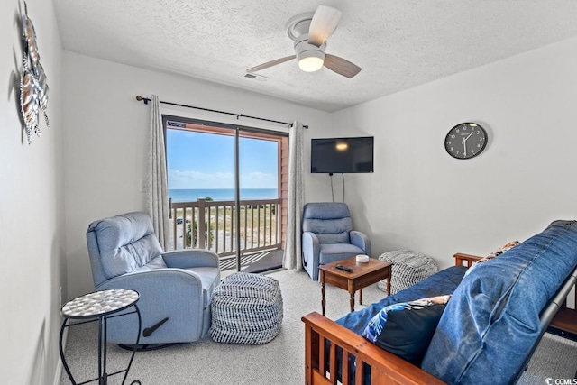 2710 S Ocean Blvd Unit 402, Myrtle Beach, SC 29577 - living area featuring light colored carpet, a textured ceiling, and ceiling fan