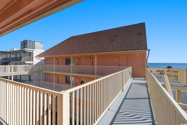 2710 S Ocean Blvd Unit 402, Myrtle Beach, SC 29577 - rear view of property with a water view, roof with shingles, and a balcony