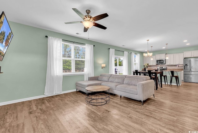 408 Carmello Cir, Conway, SC 29526 - living area featuring light wood finished floors, a ceiling fan, baseboards, a chandelier, and recessed lighting