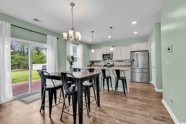 408 Carmello Cir, Conway, SC 29526 - dining room with baseboards, a chandelier, light wood-style floors, and recessed lighting