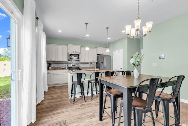 408 Carmello Cir, Conway, SC 29526 - dining area with light wood-style flooring, a chandelier, and recessed lighting