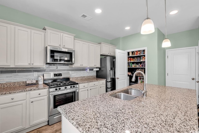 408 Carmello Cir, Conway, SC 29526 - kitchen with stainless steel appliances, a sink, white cabinetry, decorative backsplash, and recessed lighting