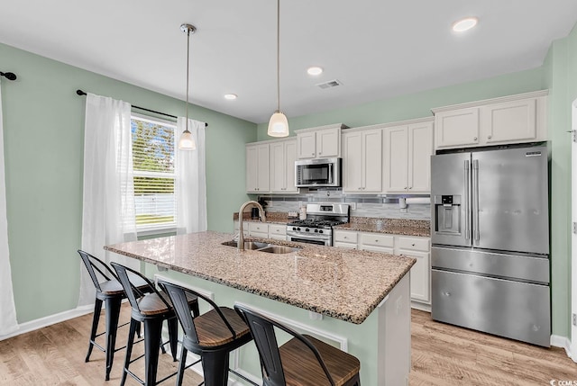 408 Carmello Cir, Conway, SC 29526 - kitchen with stainless steel appliances, a sink, a center island with sink, white cabinetry, and recessed lighting