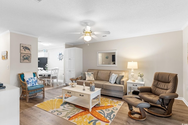 9776 Leyland Dr Unit 2, Myrtle Beach, SC 29572 - living room featuring ornamental molding, light wood-style flooring, ceiling fan, a textured ceiling, and baseboards