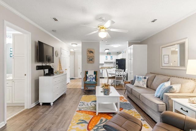 9776 Leyland Dr Unit 2, Myrtle Beach, SC 29572 - living area with light wood finished floors, a ceiling fan, and ornamental molding