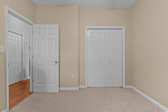 100 Lazy Willow Ln Unit 103, Myrtle Beach, SC 29588 - unfurnished bedroom featuring carpet flooring, a closet, and baseboards