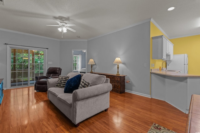 100 Lazy Willow Ln Unit 103, Myrtle Beach, SC 29588 - living room featuring light wood finished floors, a ceiling fan, ornamental molding, baseboards, and recessed lighting