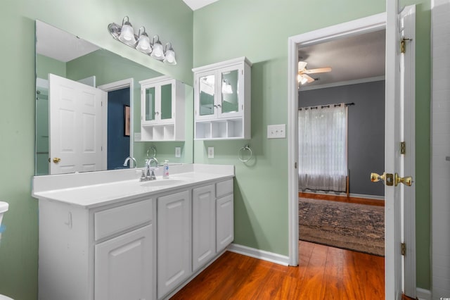 100 Lazy Willow Ln Unit 103, Myrtle Beach, SC 29588 - bathroom featuring a ceiling fan, wood finished floors, vanity, baseboards, and ornamental molding
