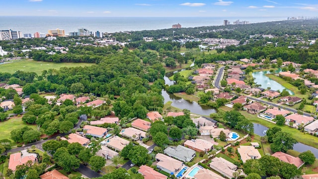 7545 Ventura Ct, Myrtle Beach, SC 29572 - aerial view of property and surrounding area featuring a large body of water, nearby urban area, and a tree filled landscape