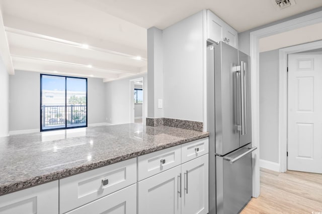 601 Mitchell Dr Unit 207, Myrtle Beach, SC 29577 - kitchen featuring high end fridge, stone countertops, white cabinetry, and light wood-type flooring