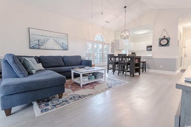 698 Riverwalk Dr Unit 304, Myrtle Beach, SC 29579 - living room with light wood finished floors, a chandelier, high vaulted ceiling, and baseboards